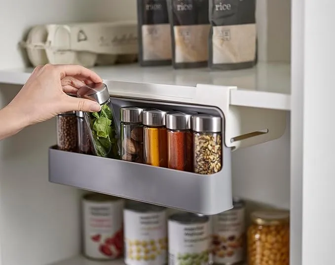 A well-organized kitchen countertop displaying 9 Amazon kitchen organization gadgets, including a spice and vitamin organizer, utensil holder, and beer can organizer, all trending on TikTok. The products are modern, sleek, and arranged to highlight a clutter-free and stylish kitchen space.