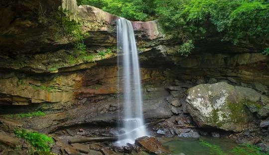 Ohiopyle State Park Waterfall – Picturesque waterfall along the Ferncliff Peninsula Trail at Ohiopyle, an adventurous places to go near me in Pennsylvania for hiking and rafting.