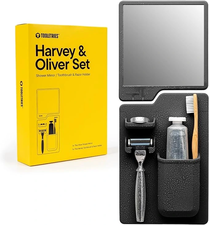 Tooletries Harvey & Oliver Set featuring a charcoal silicone shower toothbrush holder and anti-fog mirror. This versatile shower organizer measures 5.5 inches in width, 5.12 inches in depth, and 8.5 inches in height. Designed with patent silicone-grip technology, it adheres securely to shiny surfaces like glass and tiles. The set is removable and reusable, making it perfect for organizing your grooming essentials in a Western bathroom, whether at home or on the go.