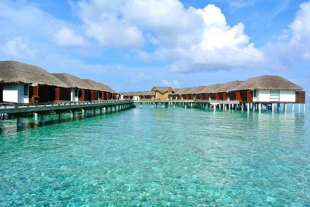 Overwater villas in the Maldives, one of the most beautiful islands, set against clear turquoise waters and vibrant coral reefs.