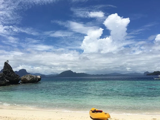 Aerial view of El Nido’s limestone cliffs and turquoise lagoons in Palawan, one of the most beautiful islands in the Philippines.